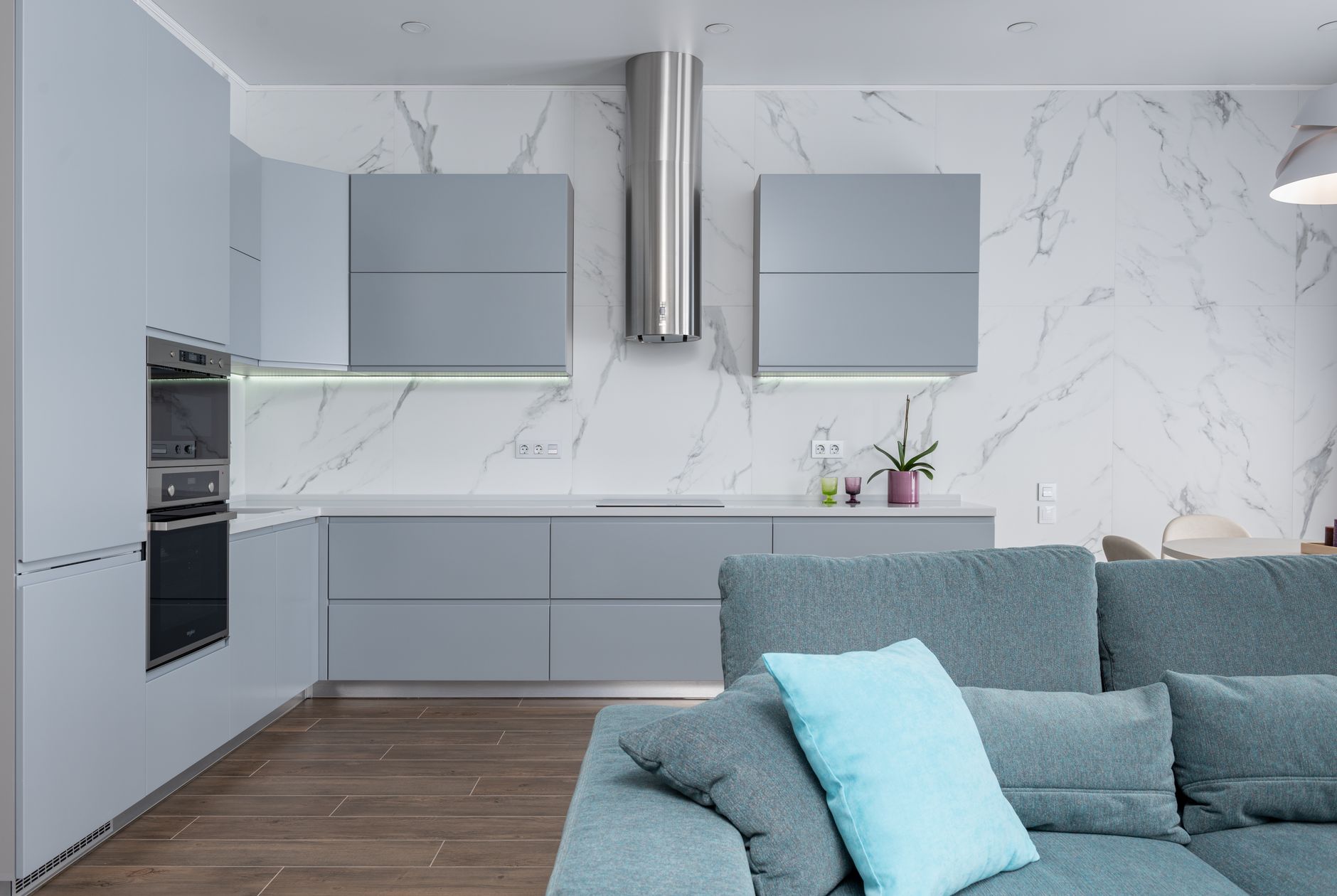 Interior of contemporary living room with new laminate and embedded microwave oven in apartment