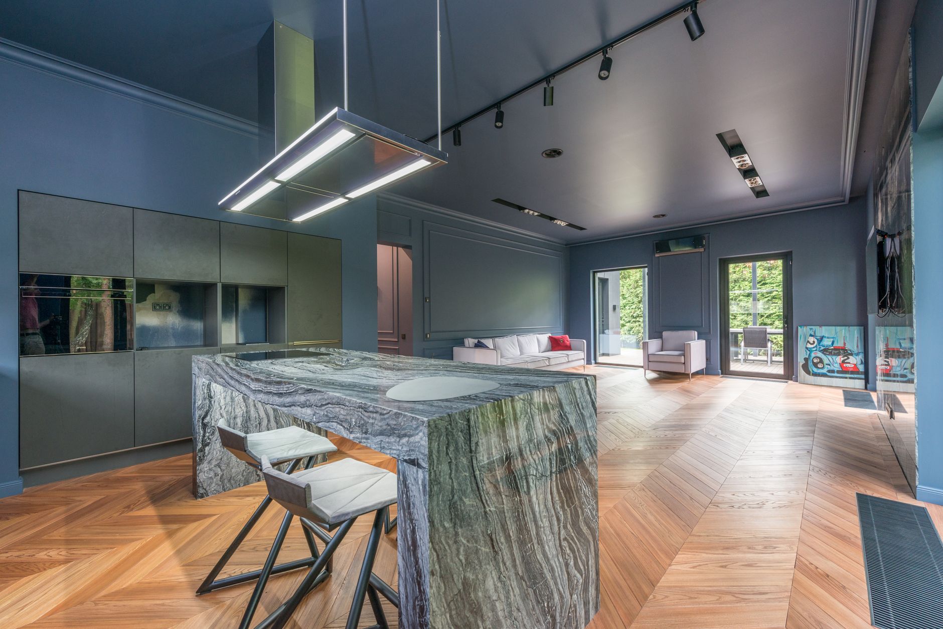 Spacious modern kitchen and living room with parquet flooring and minimalist design.