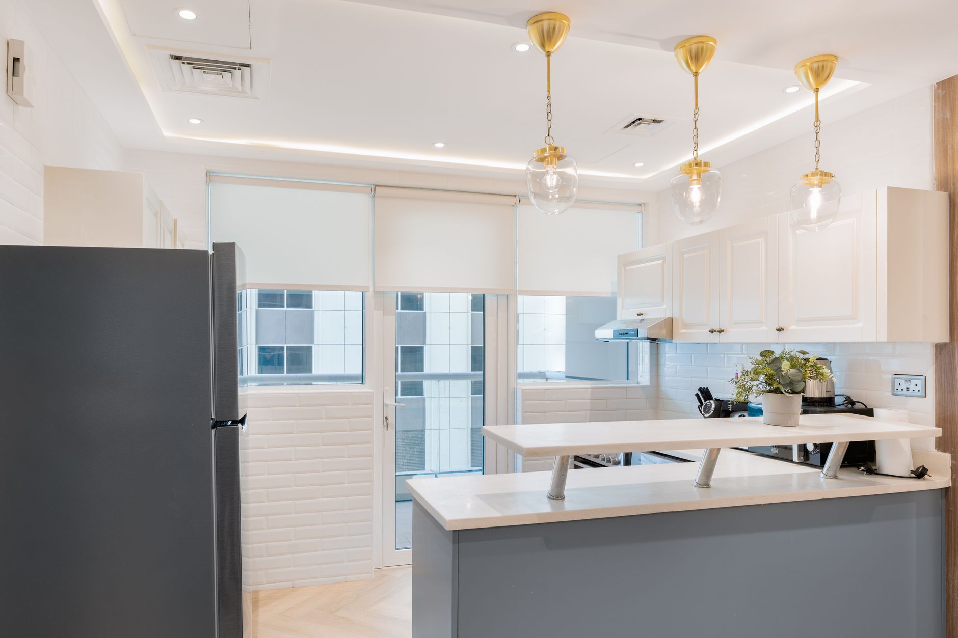 Explore a contemporary kitchen featuring elegant lighting and chic decor, blending style and function.